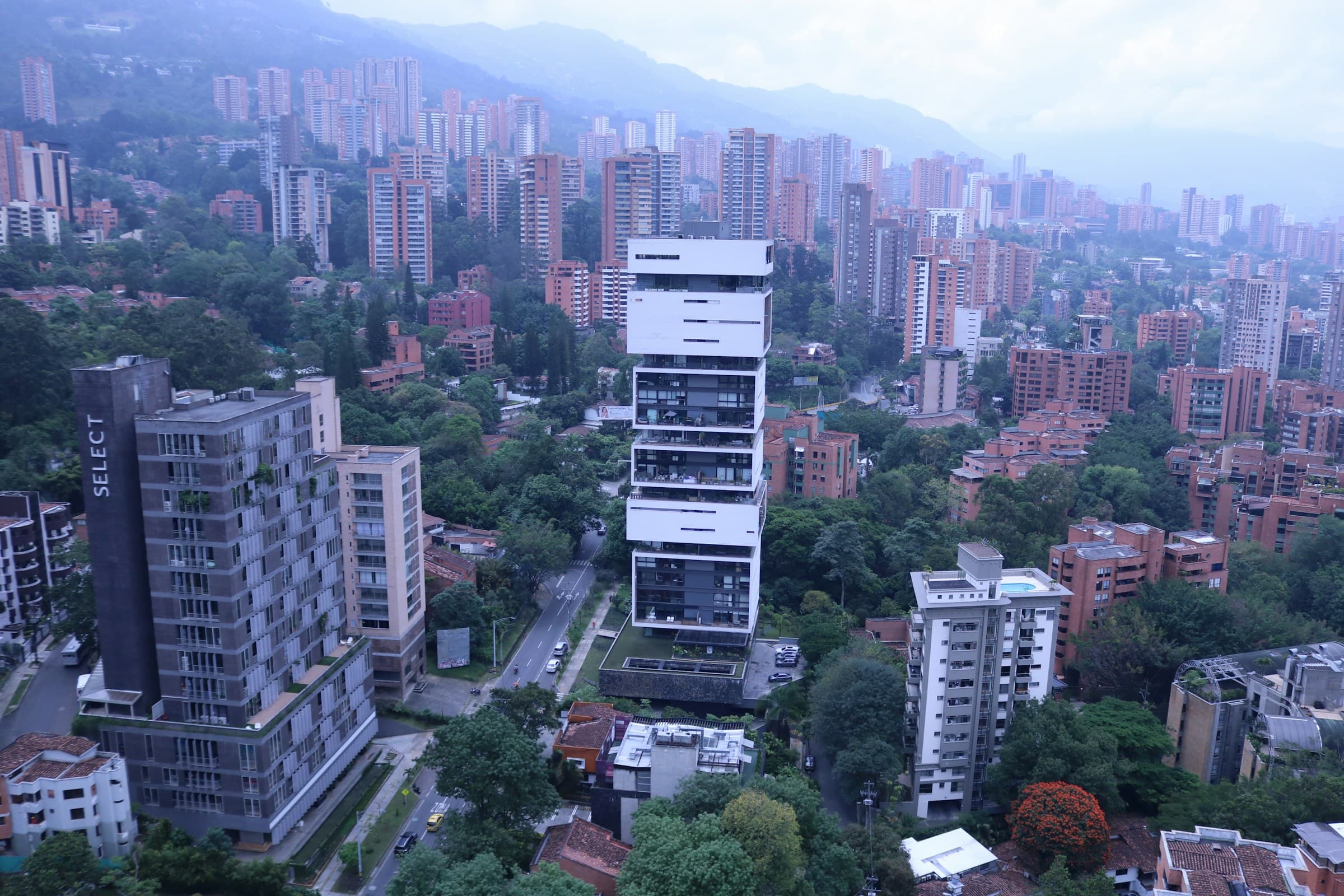 Aerial view of the buildings and tree-lined streets of El Poblado, in Medellín